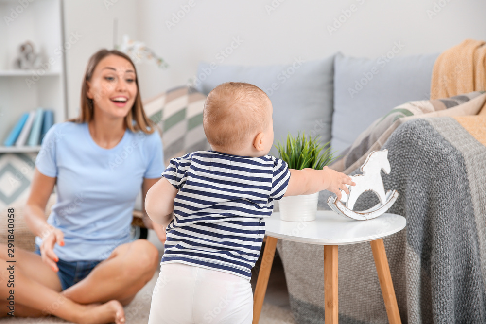 Mother with her cute little baby at home