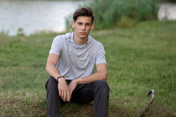 Portrait of a young handsome man outdoors. Teenager