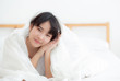 © NT_studio - Beautiful portrait young asian woman lying and smile while wake up with sunrise at morning, girl with happy annd fun in the bedroom, lifestyle and relax concept.