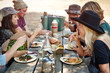 © Trinette Reed/Stocksy - Group of millennial friends having a picnic in the park together
