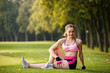 © Olga Mishyna - sport girl making exercises outdoors. Young sport woman in a park. Sport and fitness on open air. Exercise lunge leg on the grass and stretching