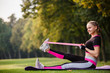 © Olga Mishyna - sport girl making exercises outdoors. Young sport woman in a park. Sport and fitness on open air. Exercise lunge leg on the grass and stretching