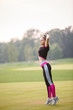 © Olga Mishyna - sport girl making exercises outdoors. Young sport woman in a park. Sport and fitness on open air. Exercise lunge leg on the grass and stretching