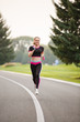 © Olga Mishyna - sport girl making exercises outdoors. Young sport woman in a park