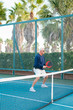 © rzcreative/Stocksy - Active senior man playing platform tennis on tennis court.
