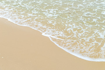 Wall Mural - Soft wave at the sea on the sandy beach. Background