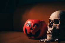 Jack-o-lantern Halloween Pumpkin With Scary Skull On Wood Table. Celebration In Halloween Autumn Holiday.