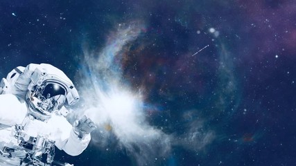 Wall Mural - astronaut in space suit in the space with nebula and stars. elements of this video furnished by nasa