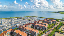 Aerial Drone View Of Typical Modern Dutch Houses And Marina In Harbor From Above, Architecture Of Port Of Volendam Town, North Holland, Netherlands
