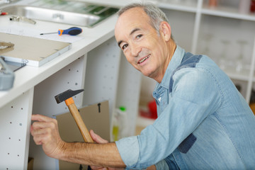 close up shot of old master carpenter at home