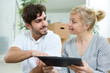 © auremar - young couple with digital tablet in their new home