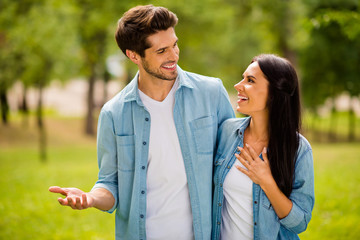 Canvas Print - Photo of charming pair walking summer park speaking overjoyed wear denim outfit