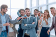 © ASDF - confident proud businessman standing in front of a friendly business team.