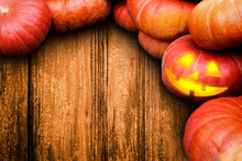 Wooden Halloween Background With Many Pumpkins And Jack O Lantern.