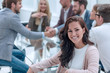 © ASDF - smiling business woman sitting in front of the table in the meeting room