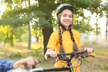 Canvas Print - Cute girl riding bicycle outdoors