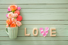 Beautiful Composition With Rose Flowers And Cup On Wooden Background