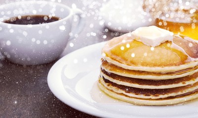 Wall Mural - Panckes with butter and syrup with coffee in the background