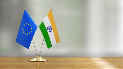 Wall Mural - European Union and Indian flag pair on a desk over defocused background 