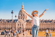 canvas print picture - Asian happy girl traveler posing in the square near the Invalides In Paris. Lifestyle and tourism in France