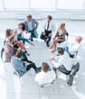© ASDF - business training participants sitting in a circle and looking at the camera