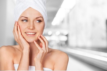 Canvas Print - Portrait of beautiful young woman  in white towel on head on background