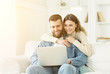© Prostock-studio - Happy couple having video-call on laptop, spending time at home