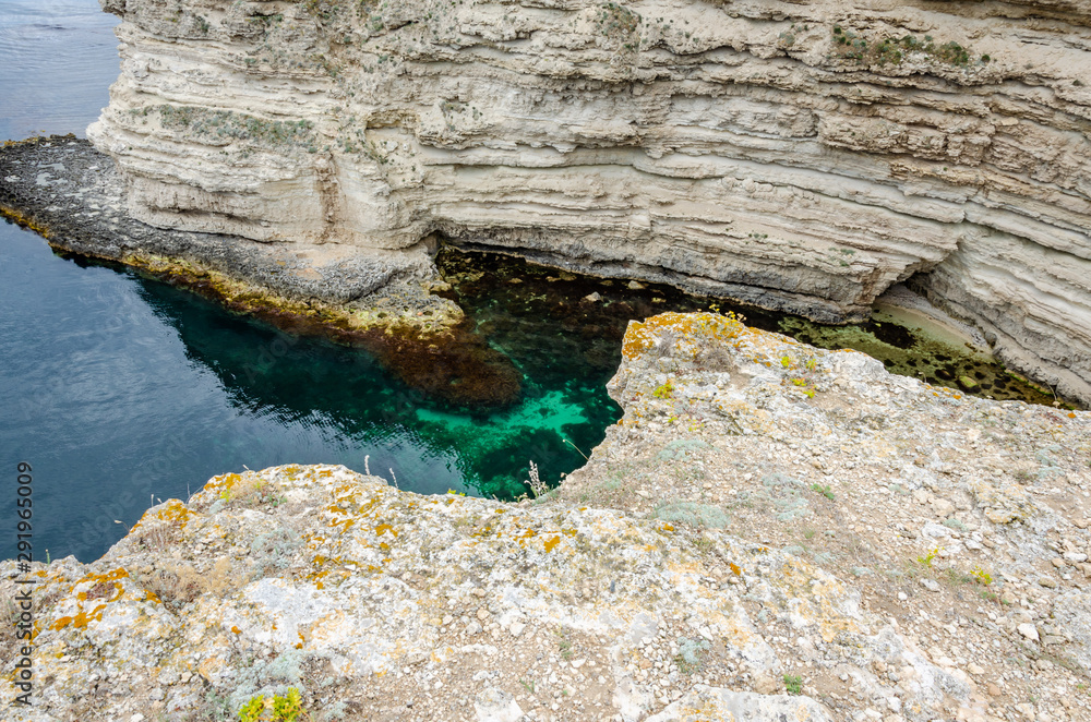 Bay among the rocks. Clear water, through which you can see the bottom ...