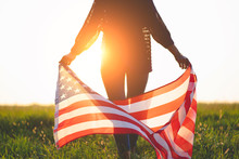 Patriotic Woman With American Flag Outdoors At Sunset. Travel To America And Celebrate Holiday Of 4th Of July In Usa