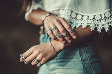 Fashionable Boho Chic Woman In A White Short Blouse With Silver Turquoise Jewelry. Boho Fashion. Stylish Girl Wearing Silver Rings With Turquoise Stone In Hippie Style.