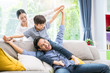 © virojt - Happy Asian family in the living room