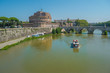 Tourist Boat and the Sant'Angelo Castle on the banks of the river Tiber in Rome, Italy