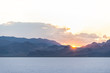 Bonneville Salt Flats blue landscape near Salt Lake City, Utah and silhouette mountain view and sunset behind clouds