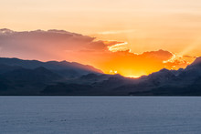 Bonneville Salt Flats Blue Orange Landscape Near Salt Lake City, Utah And Silhouette Mountain View And Sunset Behind Clouds
