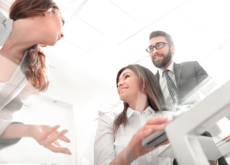 Poster - through the glass.business colleagues at the Desk