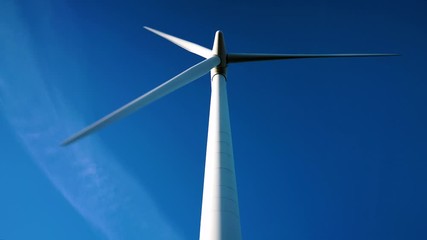 Wall Mural - Looking directly up at a large commercial wind turbine at sunrise on a clear day