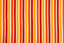 Vertical Stripes Of Yellow, Orange And Red Between White Color From Weave Craft Design On Cotton Fabric For Cozy Couch Cover Pattern Textured Background
