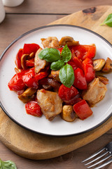 Wall Mural - Fried chicken with vegetables (tomato, pepper, onion), mushrooms and Basil. Delicious dinner, healthy traditional food