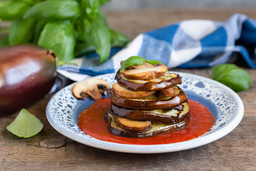 Wall Mural - Turrets of grilled eggplants and mushrooms with tomato sauce.