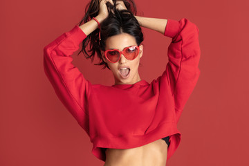 Funny beautiful girl in red sunglasses.