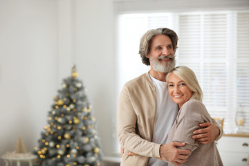 Canvas Print - Happy mature couple celebrating Christmas at home