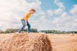 © andrey gonchar - Caucasian red-haired urban boy plays and has fun on a farm in the field
