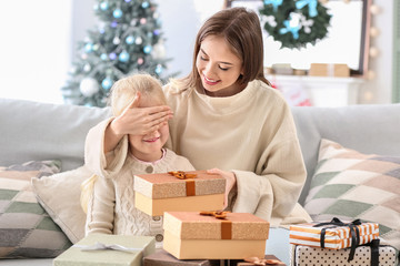 Poster - Young woman greeting her little daughter on Christmas eve