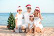 © Pixel-Shot - Happy family celebrating Christmas at tropical resort
