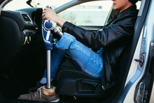 Young Man With Prosthetic Leg Driving Car. Selective Focus.