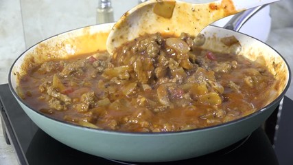 Poster - Stirring a meat sauce in a skillet