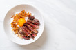 sliced beef on topped rice bowl with egg