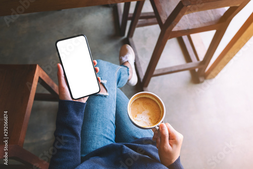 Fotografía Top view mockup image of a woman holding white mobile phone with blank screen wh