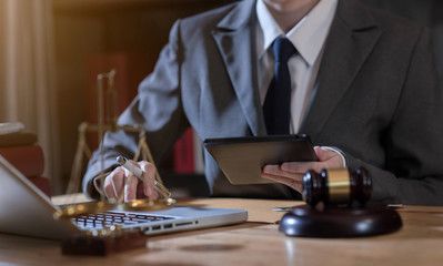 Lawyer office. gavel of Justice with scales and lawyer working on a laptop. Legal law, advice and justice concept.