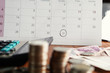 © doucefleur - debt collection and tax season concept with deadline calendar,coins,calculator on table